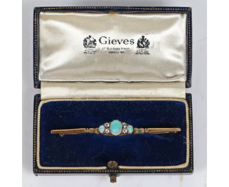 An 18 carat gold bar brooch set with a central oval opal flanked by four diamonds and a further two smaller oval opals, 59mm 