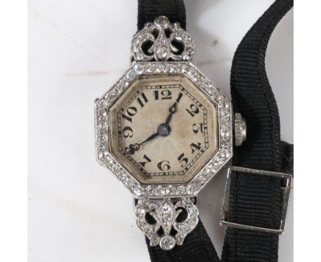 A French platinum and diamond set cocktail watch, the white engine turned dial with Arabic numerals, with pierced scrolled di