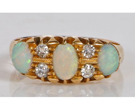 An 18 carat gold, opal and diamond ring, the head set with three oval opals interspersed by four round cut diamonds, ring siz