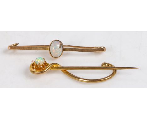 A 15 carat gold bar brooch set with a central opal, 41.5mm wide, 1.9g,&nbsp;a 9 carat gold stick pin set with an opal above a