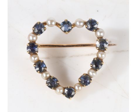 A yellow metal, sapphire and pearl heart form brooch, the pierced heart form brooch bordered with alternating sapphires and p