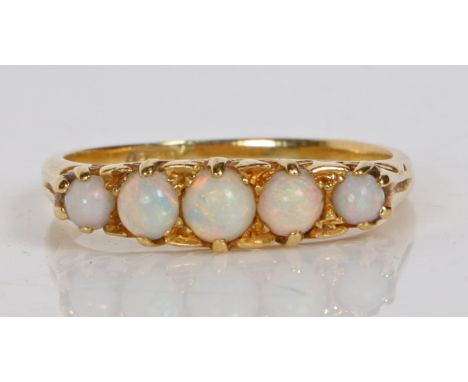 An 18 carat gold and opal ring, the head set with five graduated circular opals, ring size Q, 3.7g