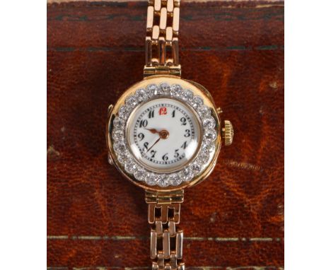 An 18 carat gold and diamond set ladies cocktail watch, the white dial with Arabic numerals, the bezel set with twenty-four r