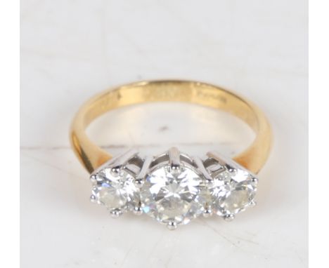 An 18 carat gold and diamond ring, the central 0.8ct diamond flanked by two 0.4ct diamonds, ring size M, 3.8g