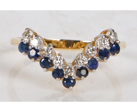 An 18 carat gold, sapphire and diamond ring, the V shaped head set with nine round cut sapphires and diamonds, ring size Q, 2