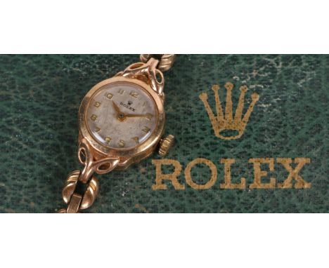 A Rolex 9 carat gold ladies wristwatch, the signed silver dial with Arabic markers, manual wound, the case 17mm wide, on a 9 