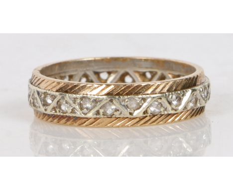 A 9 carat gold and diamond full eternity ring, the central white gold band set with round cut diamonds flanked by a reeded ye