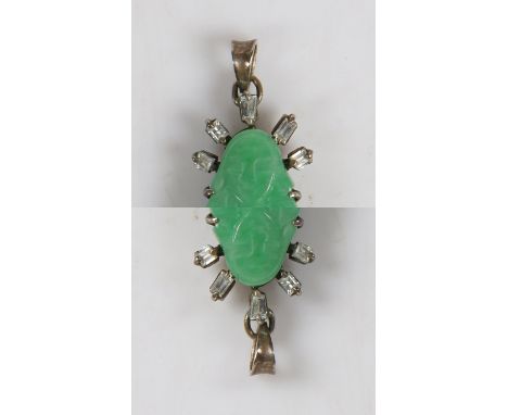 A white metal, jade and diamond pendant, modelled as Guanyin surrounded by twelve baguette and square cut diamonds, 17mm wide
