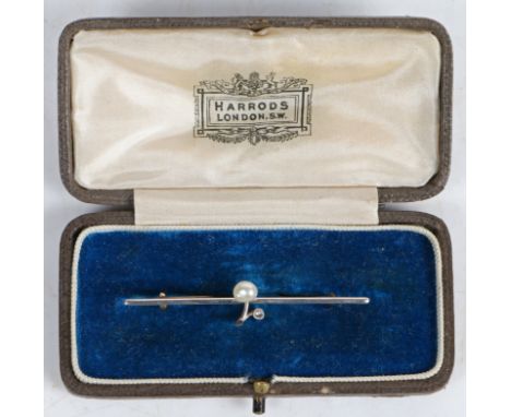 An Edwardian yellow and white metal bar brooch, the bar with central stylised branch set with a single pearl and diamond, 52.