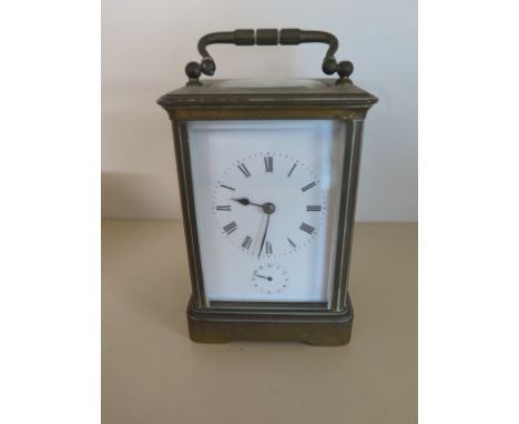 A brass four glass carriage clock with alarm striking on a bell - Height 14cm - working in the sale room, no key, frame sligh