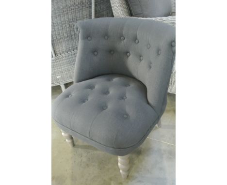 A new button back bedroom chair in charcoal grey