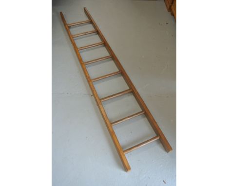 An eight rung pine ladder waxed for decorative use - Height 203cm x Width 36cm