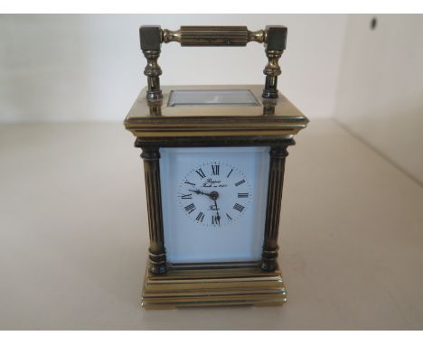 A small brass carriage clock with French movement in five glass panel case - Height 11cm x 5.9cm x 2.5cm - over wound