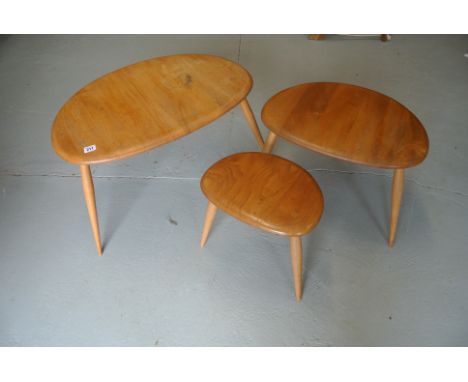 A nest of Ercol light elm pebble side tables - largest one has marks to top, other five good - minor marks to legs