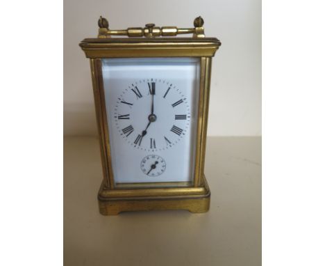 A French brass carriage clock with alarm striking on two gongs - Height 14cm - ticks but stops, no key, dial and glass good, 