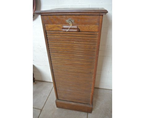 An oak Lebus filing cabinet with a tambour front and rising top - Height 119cm x 49cm x 43cm