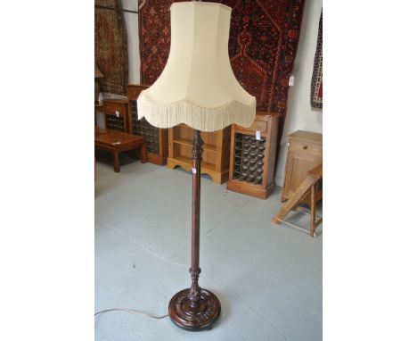 A good quality mahogany standard lamp with carved features to column and base, with shade - Height 174cm