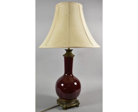 A Sang Boeuf Glazed Vase Shaped Table Lamp with Ormolu Mounts and Stand Having Dolphin Supports, Complete with Shade, 77cm hi