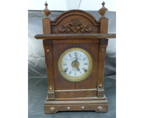 Fattorini and Sons Patent Automatic Alarm Clock 'Bradford' Patent No. 16226. Clock in Light oak with floral motif finial to t