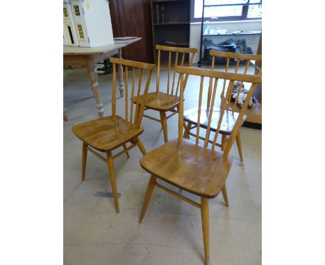 Set of four blonde Ercol stickback chairs of simple design