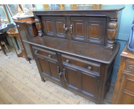 ERCOL dark oak sideboard the upper portion fitted double shelved cupboard the lower fitted 2 small drawers with double base c