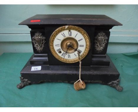 Ornate circular brass and enamel dialed mantleclock inset Roman Numerals all within black slated case
