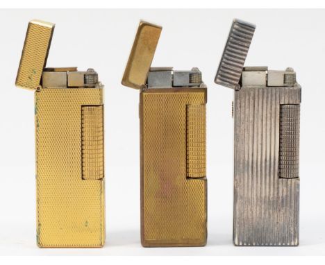 Alfred Dunhill; Three Dunhill rollagas pocket cigarette lighters, gold and silver plated examples. (3)