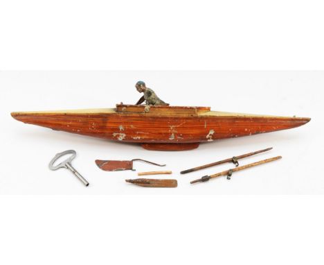 A Gebrüder Bing tinplate row boat, fitted with a lone oarsmen, German, c.1902, 50cm in length. In need of restoration. See Pr