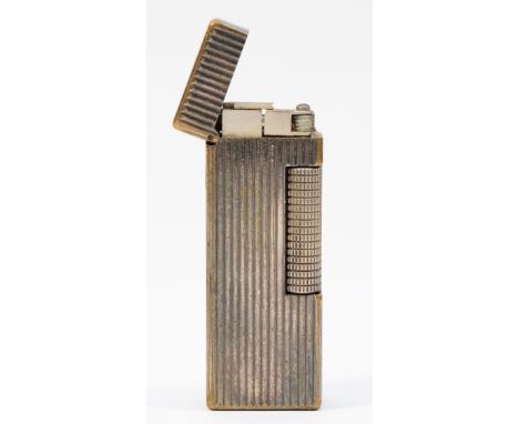 Alfred Dunhill; A silver plated Dunhill rollagas pocket cigarette lighter, having ribbed pattern casing.