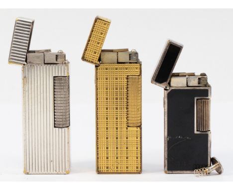 Alfred Dunhill; Three Dunhill rollagas pocket cigarette lighters, to include silver and gold plated and a ladies black enamel