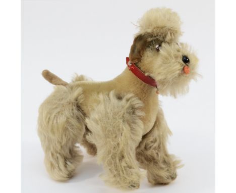 A vintage Steiff plush poodle dog, velvet and mohair, jointed legs with leather collar, glass nose and eyes, Steiff button to