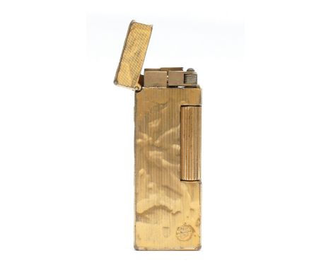 Alfred Dunhill; A rollagas pocket cigarette lighter, having gold plated stone effect casing, boxed with instructions.