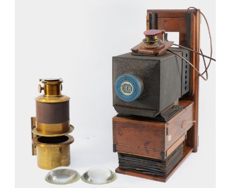 A late Victorian mahogany and tin lantern-type enlarger, together with a large brass lens attachment, and two convex glass le