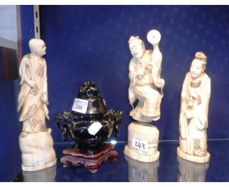 A GROUP OF THREE JAPANESE CARVED IVORY FIGURES and an 'amber' type lidded vessel 