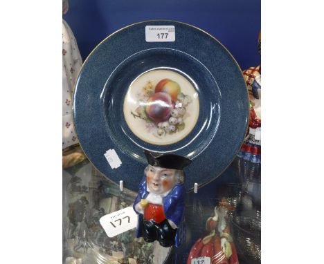 A ROYAL WORCESTER PLATE, decorated with fruit signed 'R. Sebright' and a miniature Toby Jug