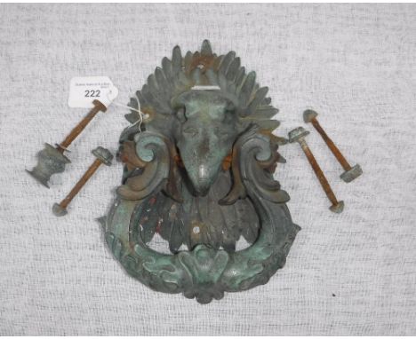 AN ELABORATE DOOR KNOCKER, the scrolling foliate cast knocker suspended from a bird's beak