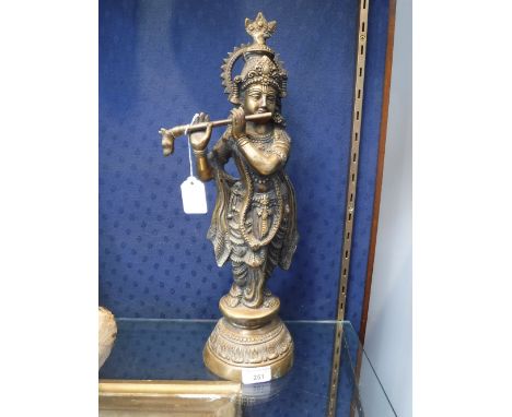 A BRONZE FIGURE OF A GODDESS PLAYING A STYLISED FLUTE