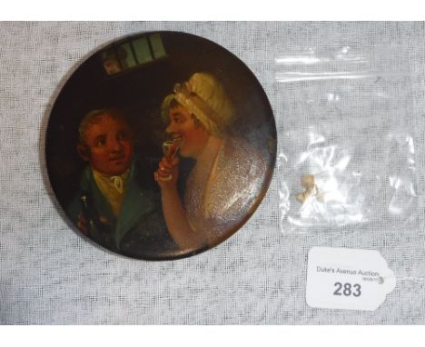 A CIRCULAR PAPIER MACHE SNUFF BOX decorated with a couple drinking wine