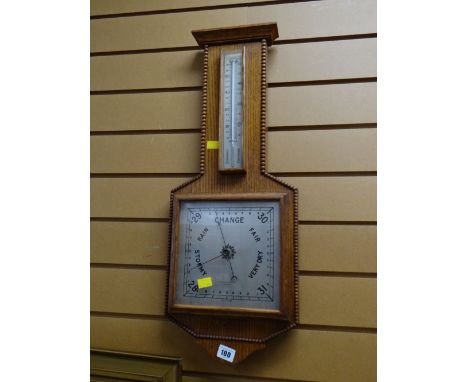 A 1950s light oak barometer made by Phillip Harris & Co, Birmingham