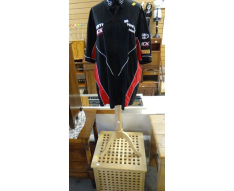 A wooden laundry basket & mannequin with a Mercedes racing shirt