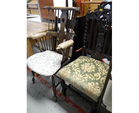 A dark oak Ercol-style Windsor armchair together with an antique profusely carved back hall chair