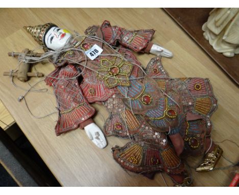 A carved wooden head Indonesian puppet doll