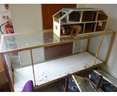 Vintage glass shop counter together with a retro beige leatherette bar / kitchen stool