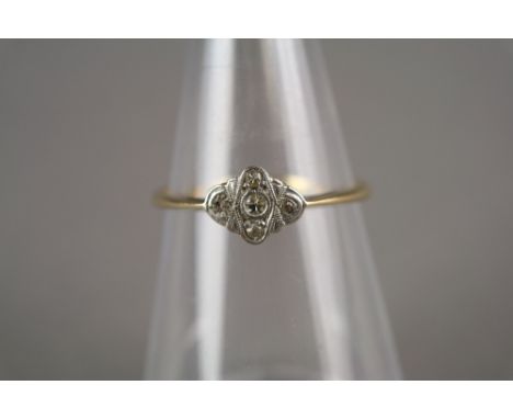 An Art Deco diamond cluster ring, the yellow metal shank stamped '18ct Plat', ring size V, weight 2.7g