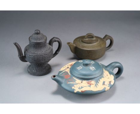 Three Chinese Yixing stoneware teapots and covers, 20th Century, the first of flattened globular form, the red clay dipped in
