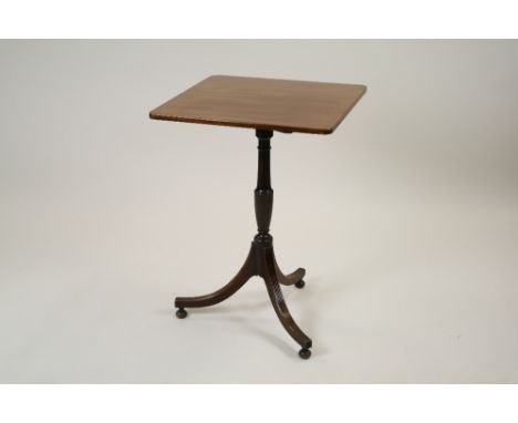 A mahogany tilt top tripod table part George III, the square top raised on a slender vase shaped column and three reeded down