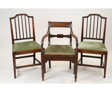 A set of four George III style mahogany rail back dining chairs, each with later upholstered drop in seat on square tapering 