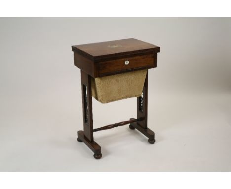 An early Victorian rosewood and ivory inlaid combined work and games table the rectangular fold over top enclosing a baize li