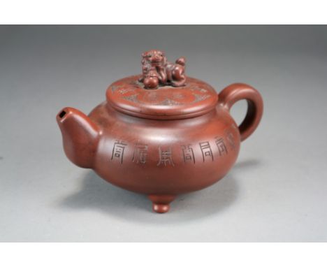 A Chinese Yixing stoneware teapot and cover, late Qing/Republic period, of compressed globular form and raised on three butto