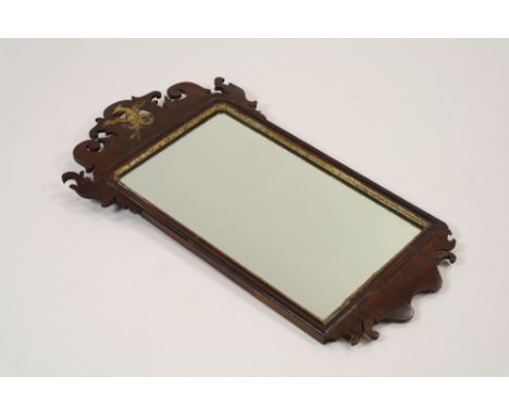 A George II style mahogany and parcel gilt bracket wall mirror with pierced surmount centred by an eagle, 77cm high, 44cm wid